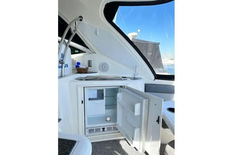  Yacht Photos Pics 2005 Cruisers 420 yacht interior with open mini fridge and sleek design.