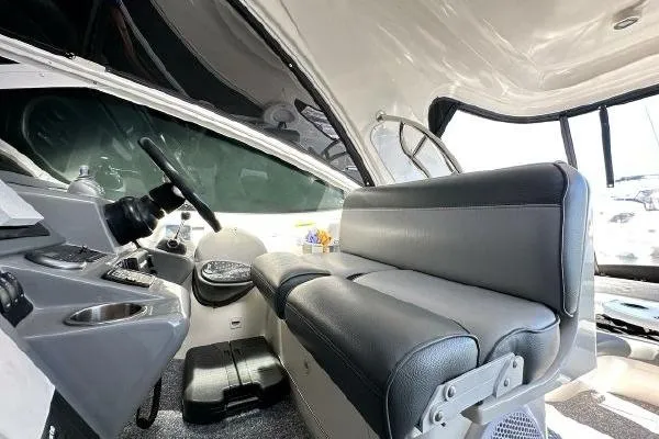  Yacht Photos Pics Interior of 2005 Cruisers 420 boat with steering wheel and seating area.