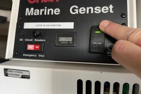  Yacht Photos Pics Control panel of a 2005 Cruisers 420 marine generator with operational indicators.