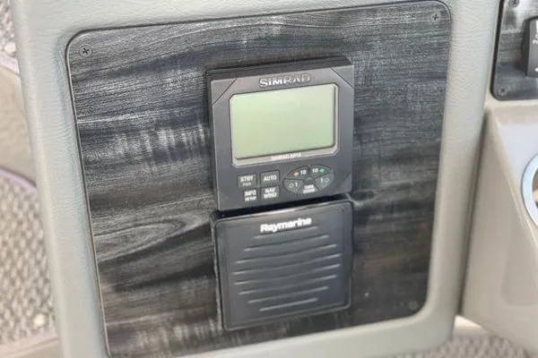  Yacht Photos Pics Control panel of a 2005 Cruisers 420 boat featuring Simrad and Raymarine devices.