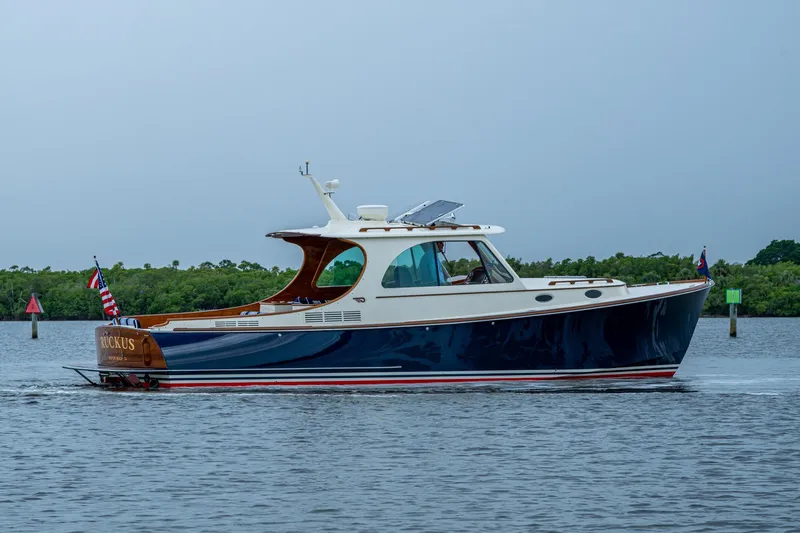 Ruckus Yacht Photos Pics 2017 Hinckley Picnic Boat 37 MKIII cruising on calm waters, side view.