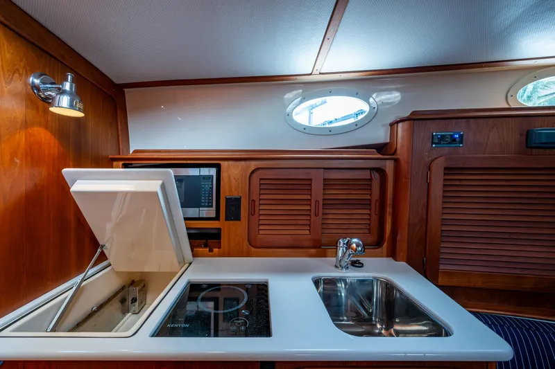 Ruckus Yacht Photos Pics 2017 Hinckley Picnic Boat 37 MKIII interior kitchen with sink, stove, and microwave.