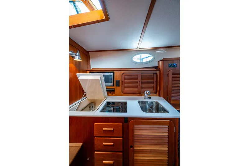 Ruckus Yacht Photos Pics Interior of 2017 Hinckley Picnic Boat 37 MKIII galley with wood cabinetry and modern appliances.