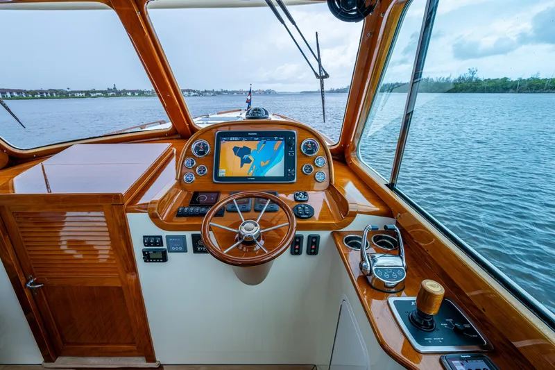 Ruckus Yacht Photos Pics Helm of 2017 Hinckley Picnic Boat 37 MKIII with navigation display and wooden finish.