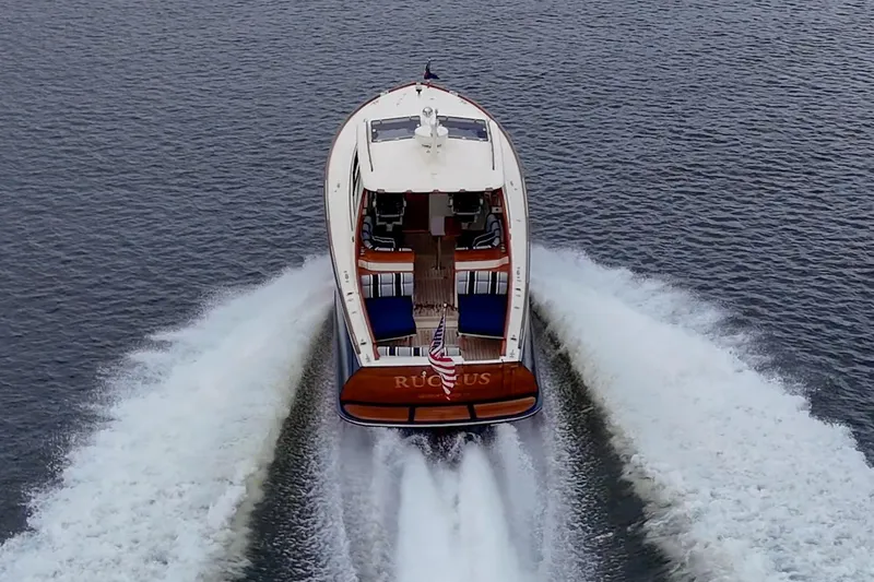 Ruckus Yacht Photos Pics 2017 Hinckley Picnic Boat 37 MKIII cruising on open water, rear view.