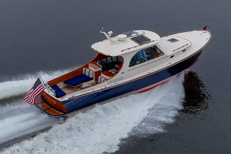 Ruckus Yacht Photos Pics 2017 Hinckley Picnic Boat 37 MKIII cruising on water, displaying American flag.