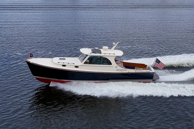 Ruckus Yacht Photos Pics 2017 Hinckley Picnic Boat 37 MKIII cruising on open water, American flag displayed.