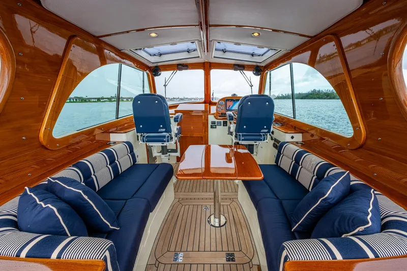 Ruckus Yacht Photos Pics Luxurious interior of 2017 Hinckley Picnic Boat 37 MKIII with elegant seating and wood finish.