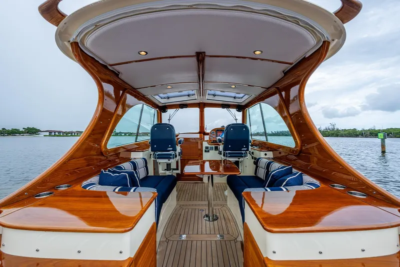 Ruckus Yacht Photos Pics 2017 Hinckley Picnic Boat 37 MKIII interior with polished wood and blue seating.