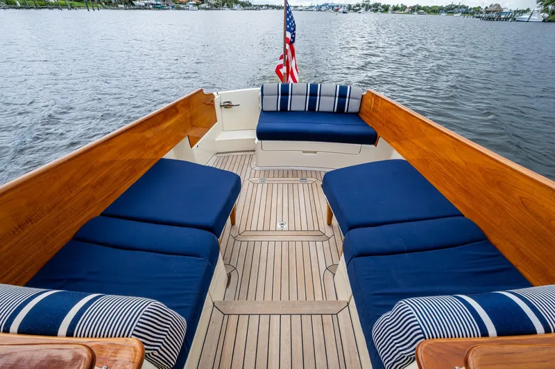 Ruckus Yacht Photos Pics 2017 Hinckley Picnic Boat 37 MKIII with blue seating and wooden deck on the water.