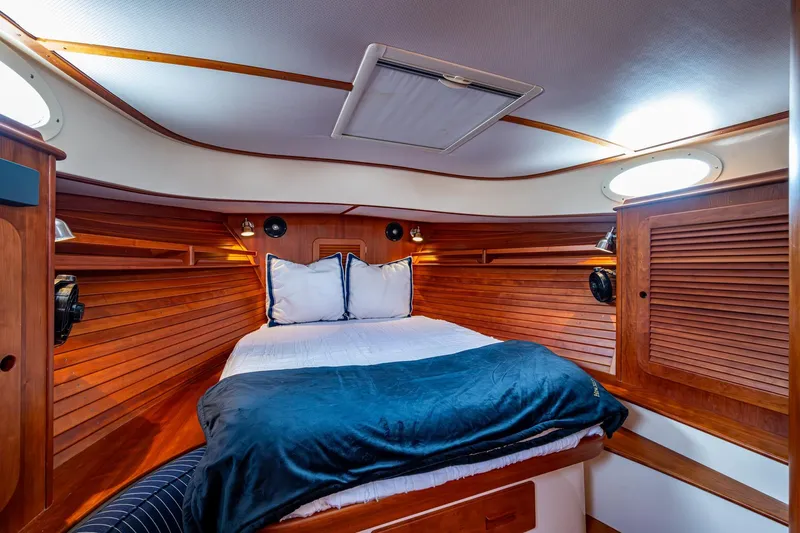 Ruckus Yacht Photos Pics Luxurious cabin interior of 2017 Hinckley Picnic Boat 37 MKIII with wooden finishes.
