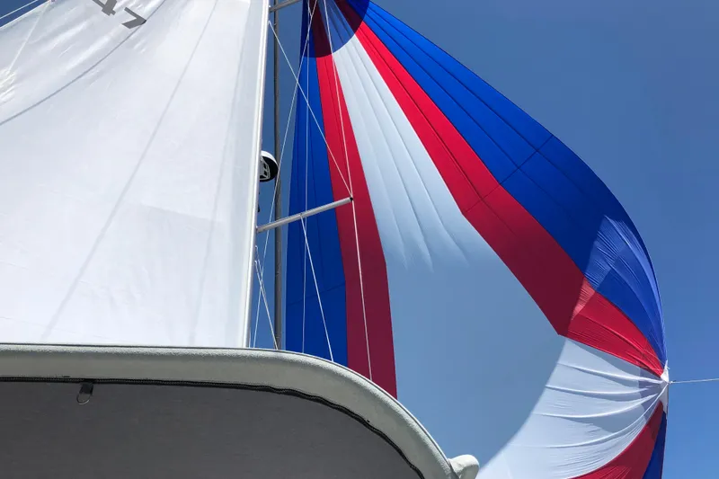 "meru" Yacht Photos Pics Sailboat with colorful spinnaker against blue sky, Catalina 425, 2019 model.