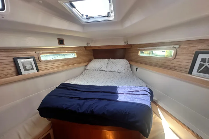"meru" Yacht Photos Pics Cozy cabin interior of 2019 Catalina 425 sailboat with double bed and wooden accents.