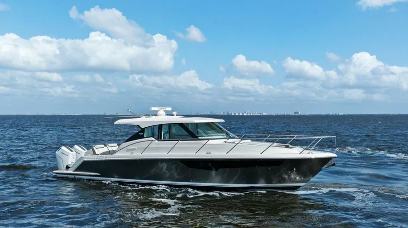  Yacht Photos Pics 2022 Tiara Yachts 43 LE cruising on open water under a clear blue sky.