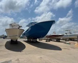  Yacht Photos Pics 2022 Yellowfin 39 Offshore boat on display under a cloudy sky.