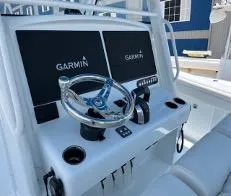  Yacht Photos Pics 2022 Yellowfin 39 Offshore boat dashboard with Garmin displays and steering wheel.