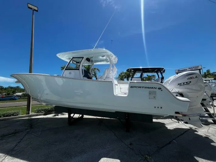  Yacht Photos Pics 2025 Sportsman 322 Open boat displayed outdoors under clear blue sky.