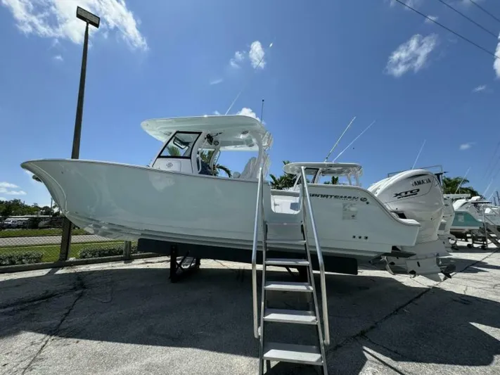  Yacht Photos Pics 2025 Sportsman 322 Open boat displayed outdoors under a clear blue sky.