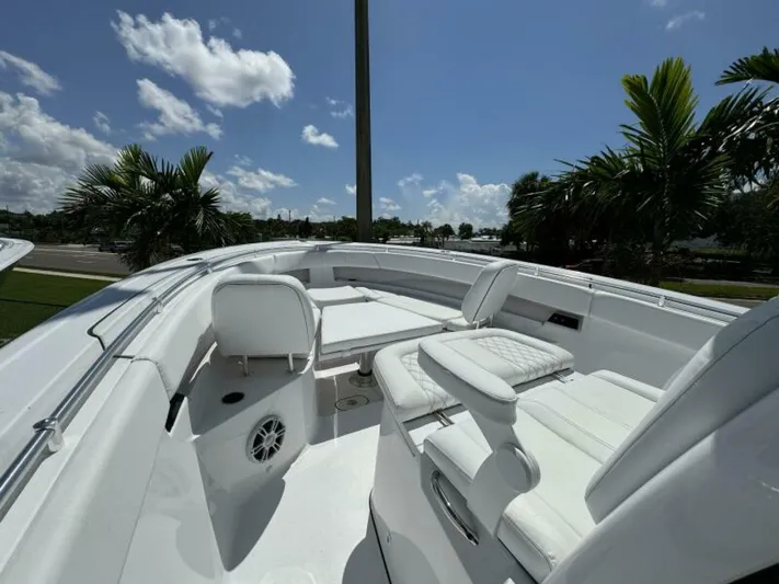  Yacht Photos Pics 2025 Sportsman 322 Open boat interior with white seating, under a clear blue sky.