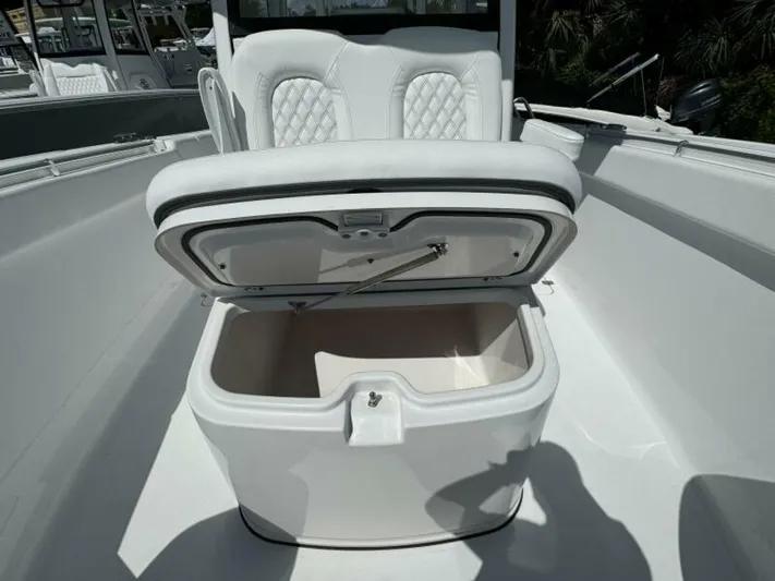  Yacht Photos Pics 2025 Sportsman 322 Open boat with open storage compartment and cushioned seating.