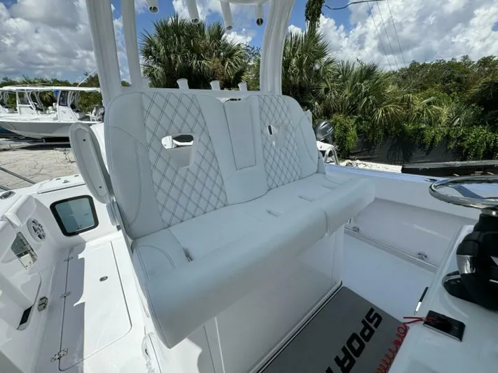  Yacht Photos Pics 2025 Sportsman 322 Open boat interior with white cushioned seating and steering wheel.