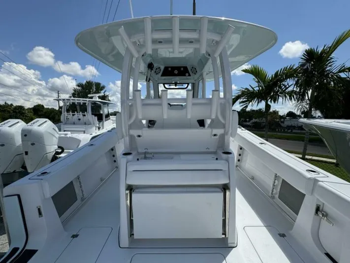  Yacht Photos Pics 2025 Sportsman 322 Open boat interior with seating and console, under a clear blue sky.