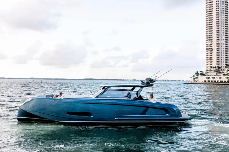 M/y Cece Yacht Photos Pics Vanquish Yachts 2022 45 T-TOP cruising on water near city skyline.