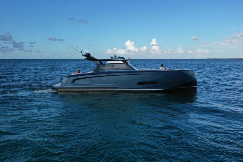 M/y Cece Yacht Photos Pics 2022 Vanquish Yachts 45 T-TOP cruising on open sea under clear blue sky.