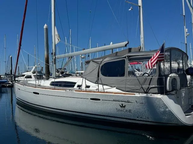 Simone Yacht Photos Pics 2007 Beneteau 490 sailboat docked in marina, featuring sleek design and American flag.