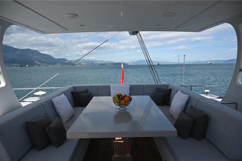  Yacht Photos Pics Luxurious Sunreef 74 yacht deck with seating, table, and ocean view, 2015 model.