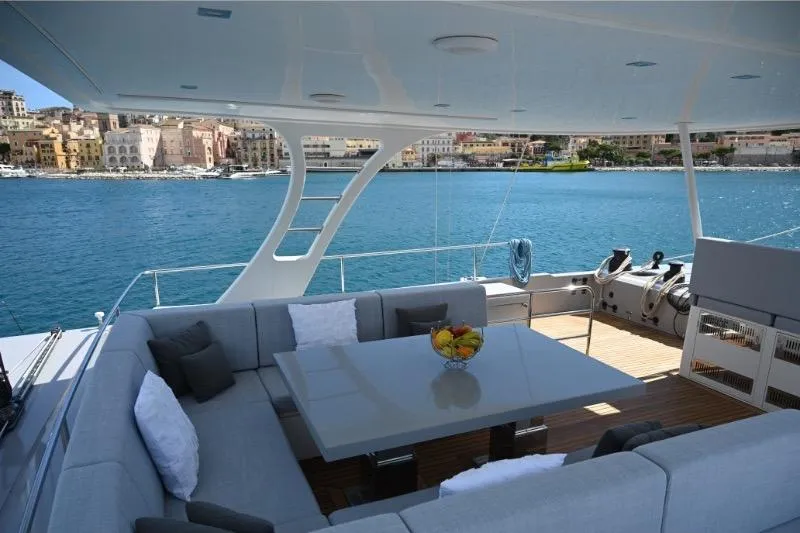  Yacht Photos Pics Luxurious Sunreef 74 yacht deck with seating area, overlooking serene blue waters, 2015 model.