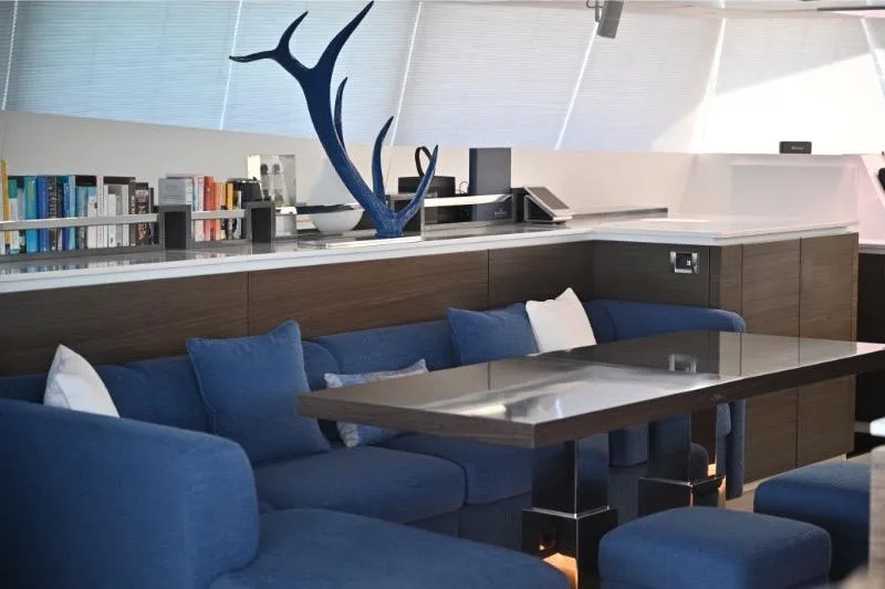  Yacht Photos Pics Luxurious interior of 2015 Sunreef 74 yacht with blue seating and modern decor.