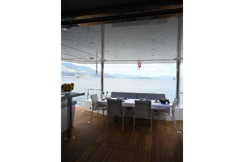  Yacht Photos Pics Luxurious Sunreef 74 yacht deck with dining area, overlooking serene ocean view, 2015 model.