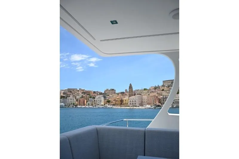  Yacht Photos Pics View from Sunreef 74 yacht, 2015 model, overlooking a coastal town and blue sea.