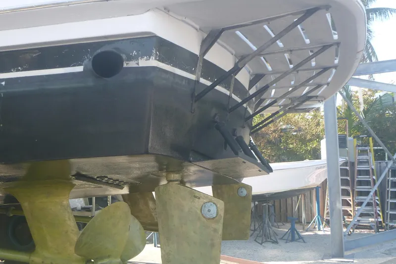 Hanalei Yacht Photos Pics 1999 Hatteras 52 Sport Deck Motor Yacht under maintenance, showcasing propellers and hull details.