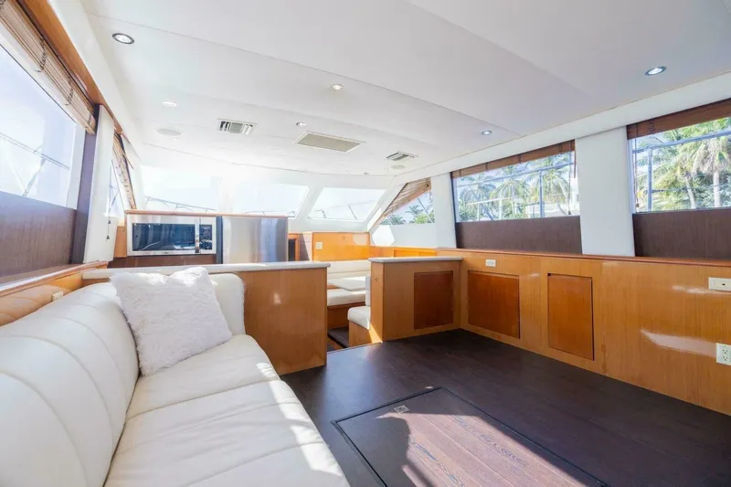 Hanalei Yacht Photos Pics Luxurious interior of 1999 Hatteras 52 Sport Deck Motor Yacht with elegant wood finishes.