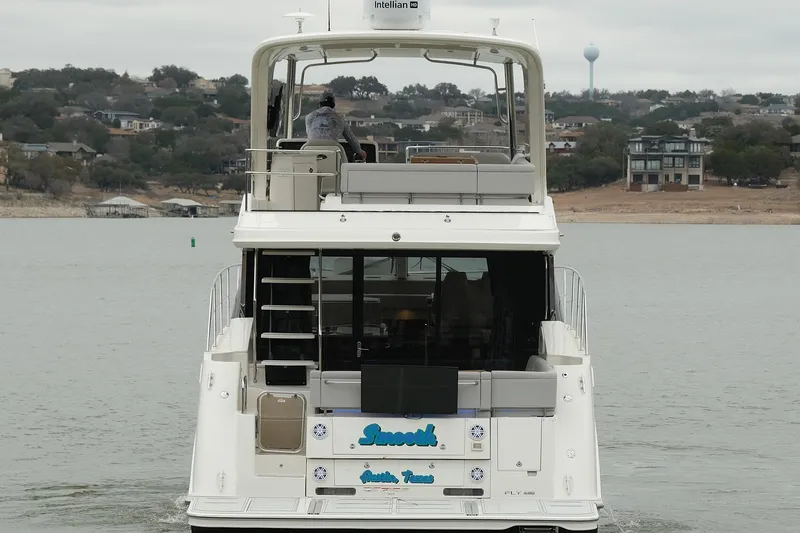 Smooth Yacht Photos Pics 2018 Sea Ray Fly 460 yacht cruising on a lake with scenic shoreline views.