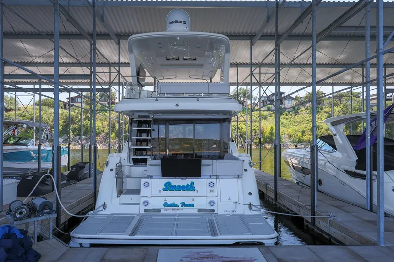 Smooth Yacht Photos Pics 2018 Sea Ray Fly 460 yacht docked in a marina, surrounded by other boats.