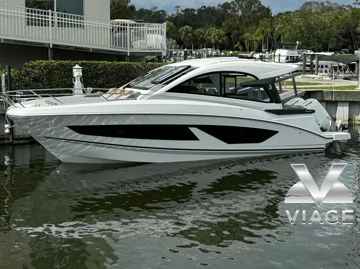  Yacht Photos Pics 2024 Beneteau Gran Turismo 32 yacht docked in a marina, side view.