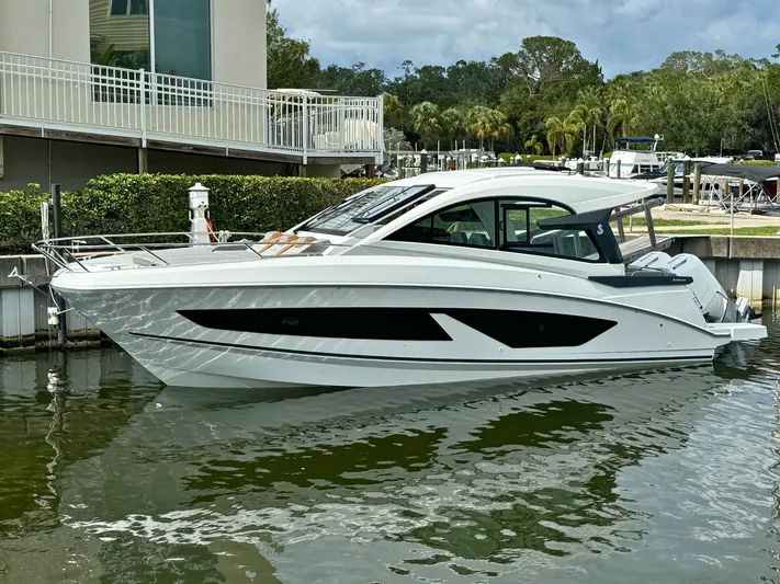 Yacht Photos Pics 2024 Beneteau Gran Turismo 32 yacht docked in a marina, showcasing sleek design and modern features.