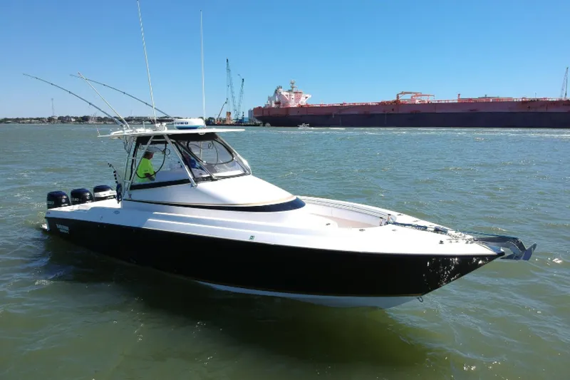 Black Friday Yacht Photos Pics 2008 Contender 36 Fish Around boat on water with industrial background.