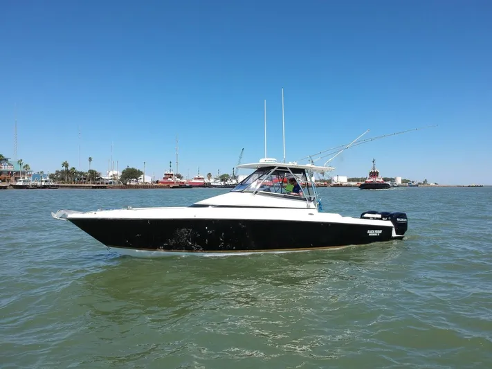 Black Friday Yacht Photos Pics 2008 Contender 36 Fish Around boat on water with clear blue sky.