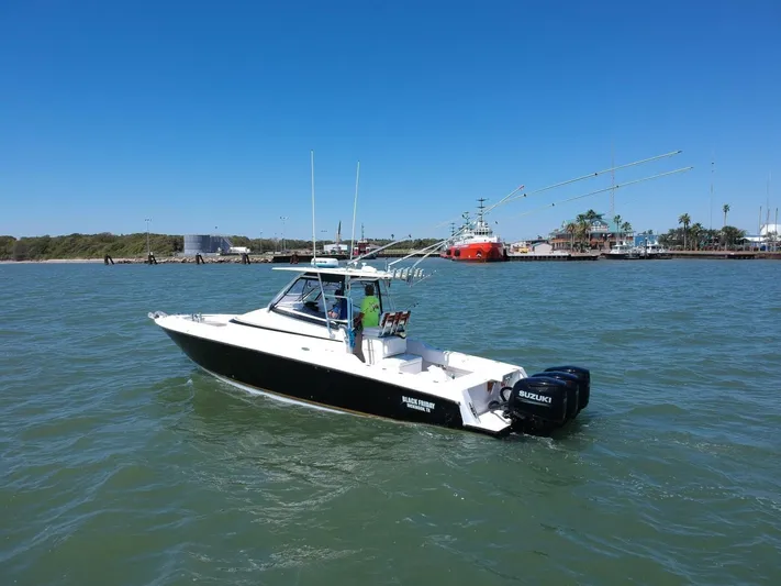 Black Friday Yacht Photos Pics 2008 Contender 36 Fish Around boat on water with Suzuki outboard engines.