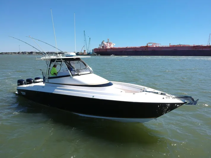 Black Friday Yacht Photos Pics 2008 Contender 36 Fish Around boat on water, side view.