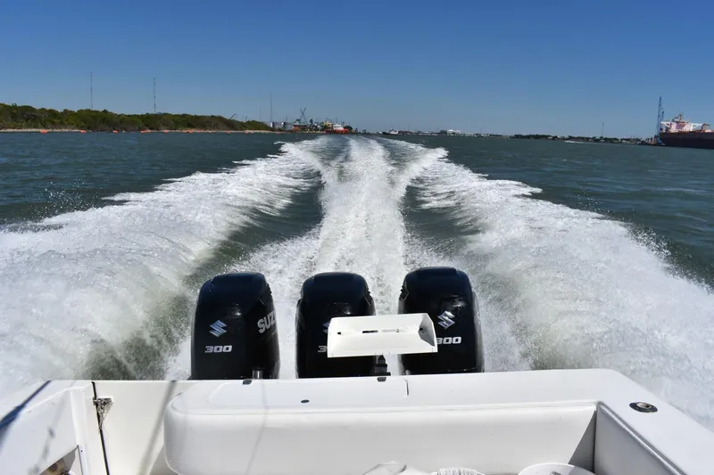 Black Friday Yacht Photos Pics 2008 Contender 36 Fish Around with triple Suzuki 300 engines cruising on water.