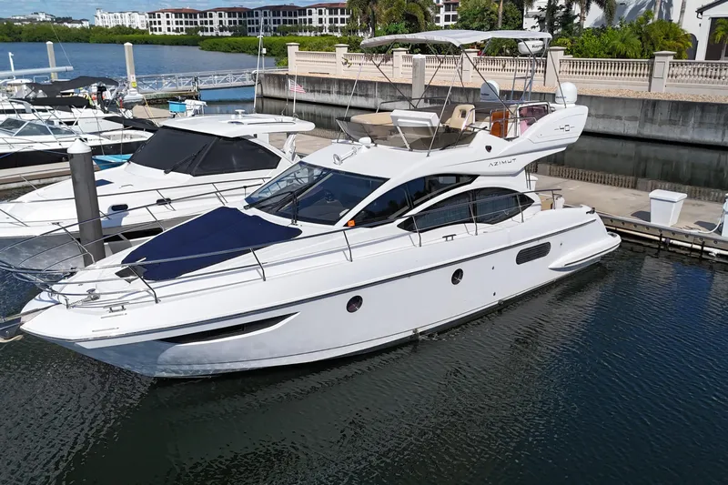  Yacht Photos Pics 2012 Azimut 40 FLY yacht docked at marina, surrounded by other boats.