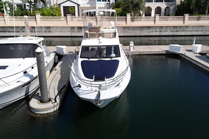  Yacht Photos Pics 2012 Azimut 40 FLY yacht docked at marina, surrounded by calm water.