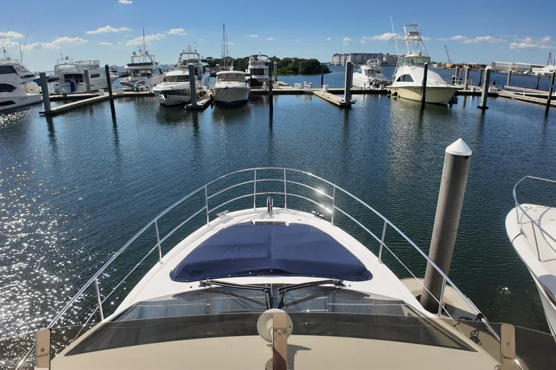  Yacht Photos Pics Bow view of 2012 Azimut 40 FLY yacht docked in a sunny marina.