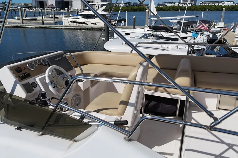  Yacht Photos Pics Flybridge of 2012 Azimut 40 FLY yacht with beige seating and steering wheel.