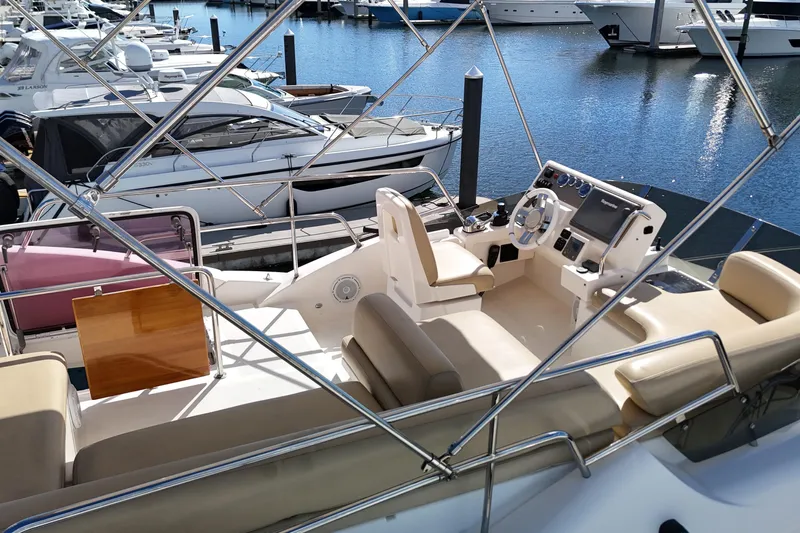  Yacht Photos Pics Flybridge of 2012 Azimut 40 FLY yacht docked at marina, featuring helm and seating area.